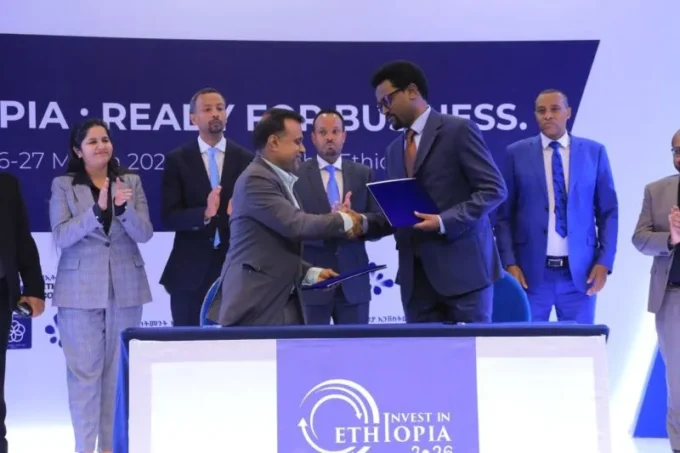 Ethiopia celebrating a $13 billion investment deal haul, with visuals of business leaders, financial charts, and infrastructure projects, highlighting investor surprise and economic optimism.