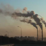 India climate policy illustration showing the 2035 NDC emissions intensity target, with carbon reduction charts, industrial activity, and renewable energy transition visuals highlighting sustainability goals.