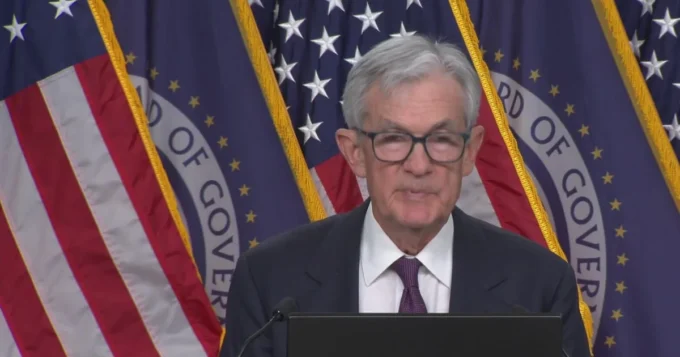 Global financial markets under stress as the Iran conflict drives oil price spikes, with inflation charts rising and central bank imagery highlighting pressure on the Federal Reserve’s ability to keep inflation expectations anchored.