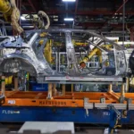General Motors idling its flagship electric vehicle factory, with halted production lines and EV models, highlighting a strategic shift amid slowing demand and changing market conditions.