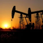 Silhouettes of oil pumpjacks at sunset, representing higher oil prices and their impact on Nigeria’s stock market rally and energy sector performance.